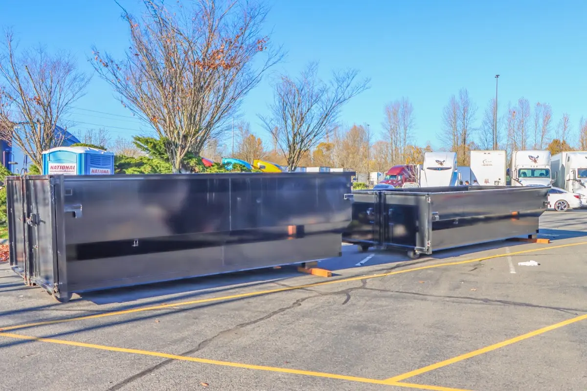 Professional dumpster rental service with roll-off container on residential driveway in Dubuque